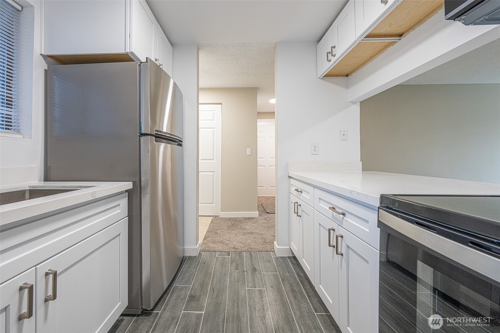 3302 I Street Northeast, Unit B103 Auburn, WA 98002 - Photo 4 of 23 a kitchen with a refrigerator stove and sink