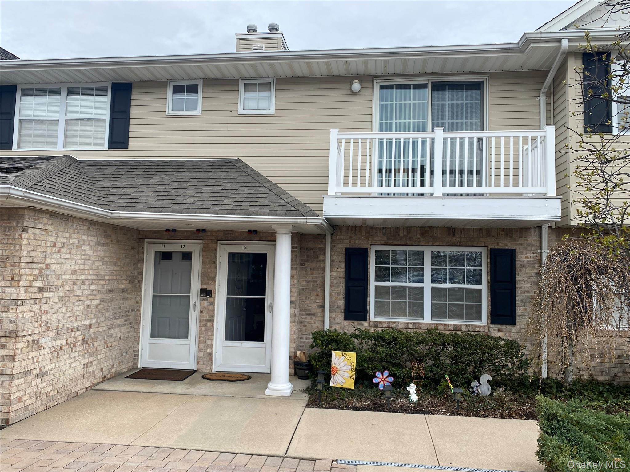 7 Dominick Court, Unit 7 Lindenhurst, NY 11757 - Photo 1 of 1 a front view of a house with a garden
