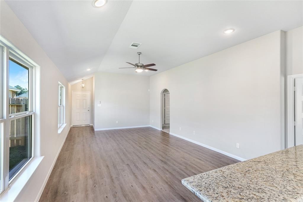 1821 Hidden Cedar Court Conroe, TX 77301 - Photo 3 of 10 wooden floor in an empty room with a window