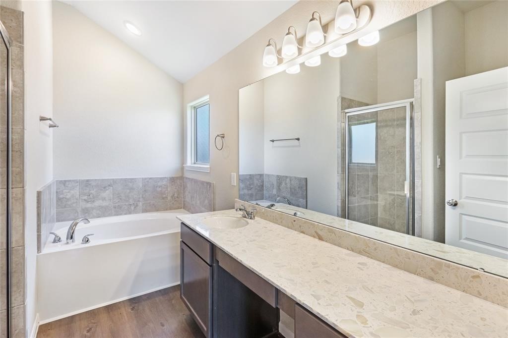 1821 Hidden Cedar Court Conroe, TX 77301 - Photo 6 of 10 a bathroom with a granite countertop sink a large mirror and a bathtub