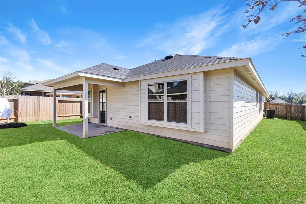 1821 Hidden Cedar Court Conroe, TX 77301 - Photo 10 of 10 a front view of a house with a yard and porch
