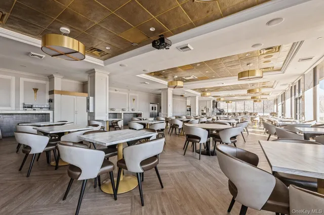 a view of a swimming pool with a chair and tables in the back yard
