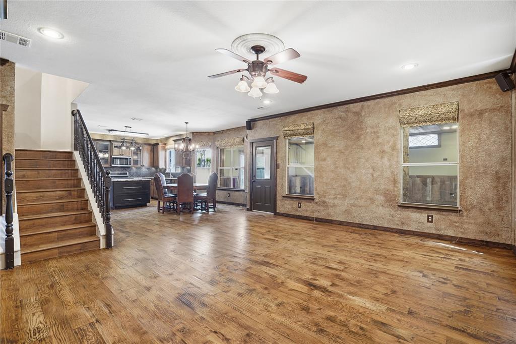 2133 Rustic Ridge Drive Keller, TX 76248 - Photo 14 of 40 Living area featuring dark wood finished floors, a ceiling fan, a chandelier, and crown molding