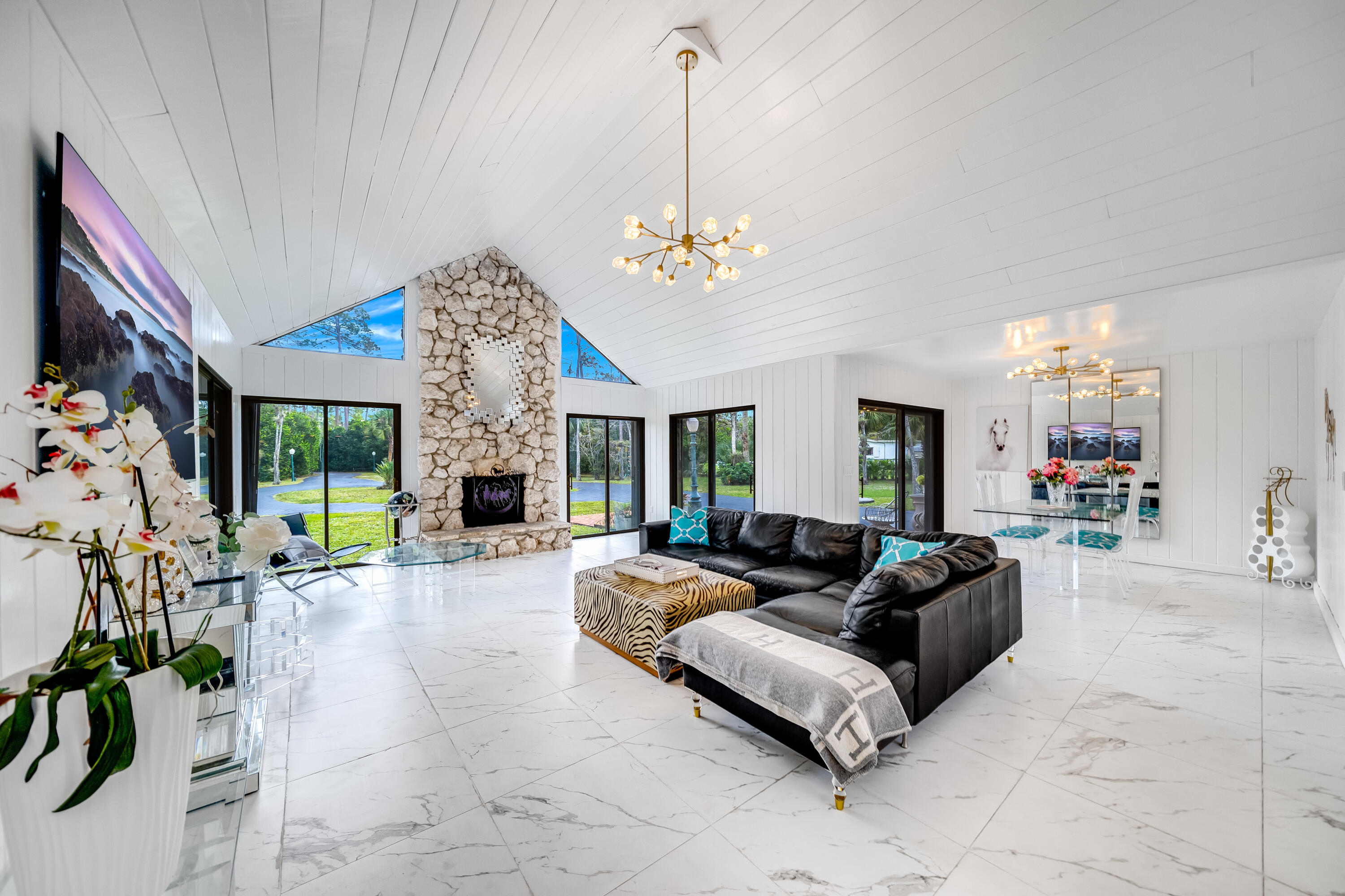 a living room with furniture large window and flat screen tv