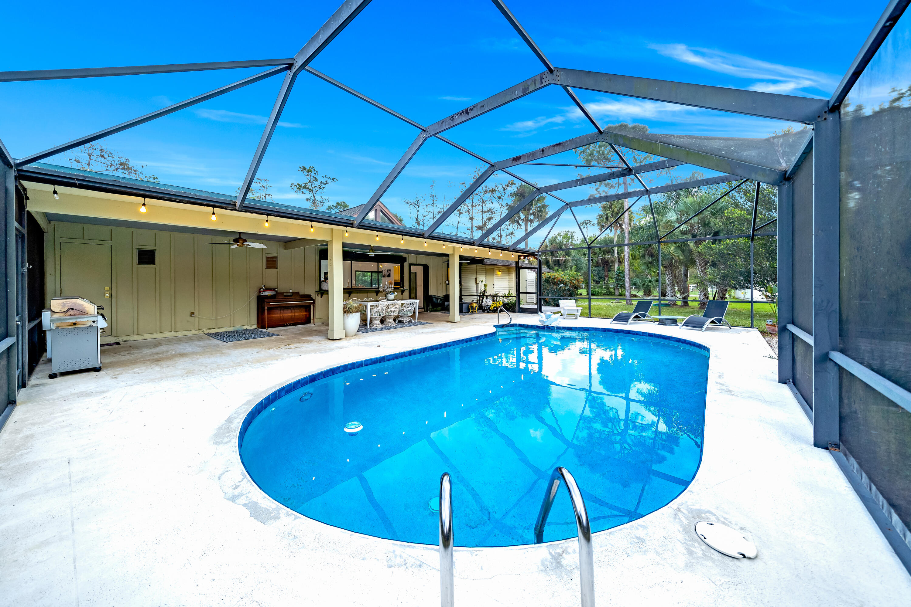 583 Rambling Dr Circle Wellington, FL 33414 - Photo 23 of 40 a view of a swimming pool with a patio