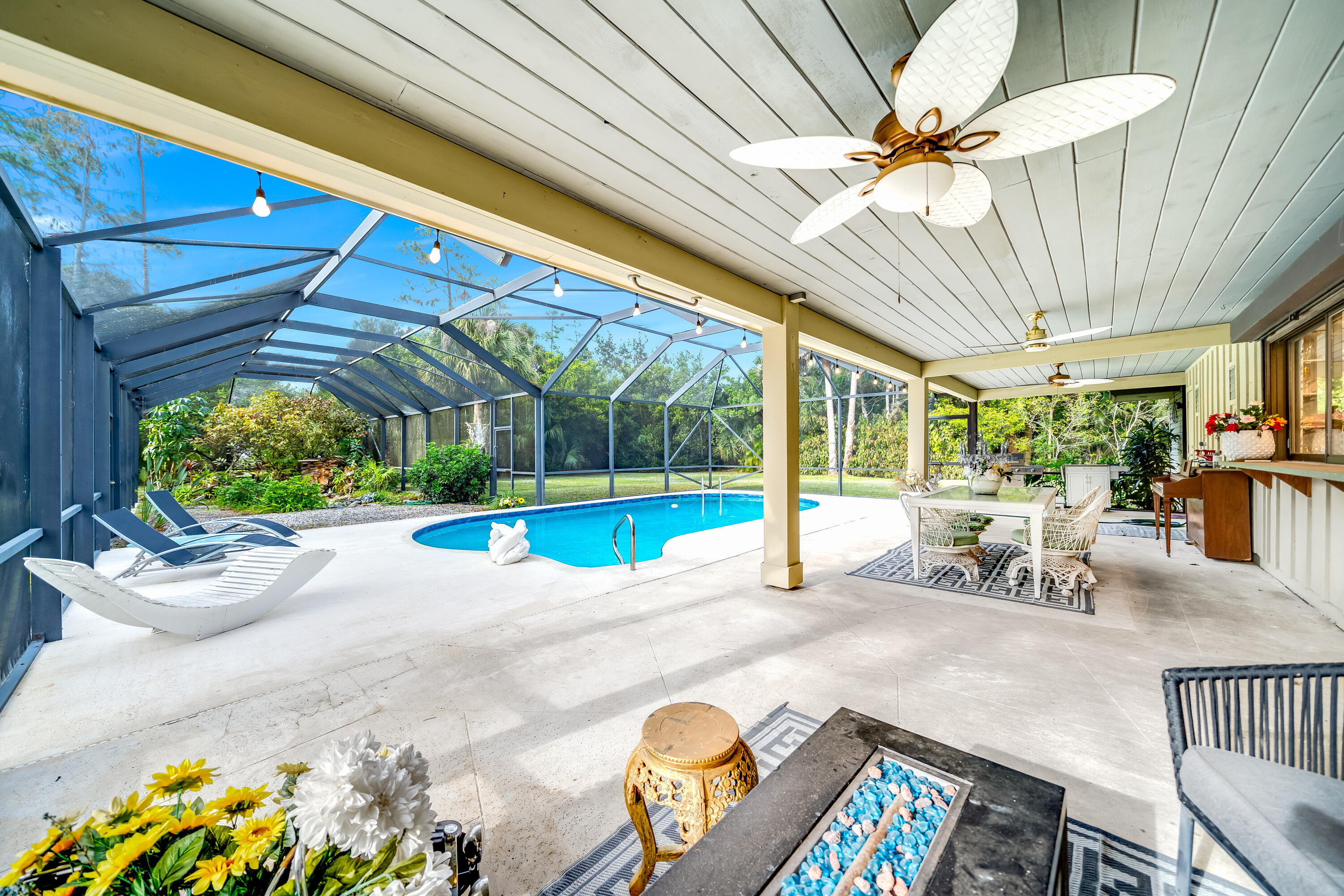 583 Rambling Dr Circle Wellington, FL 33414 - Photo 24 of 40 a view of a patio with table and chairs potted plants with wooden floor