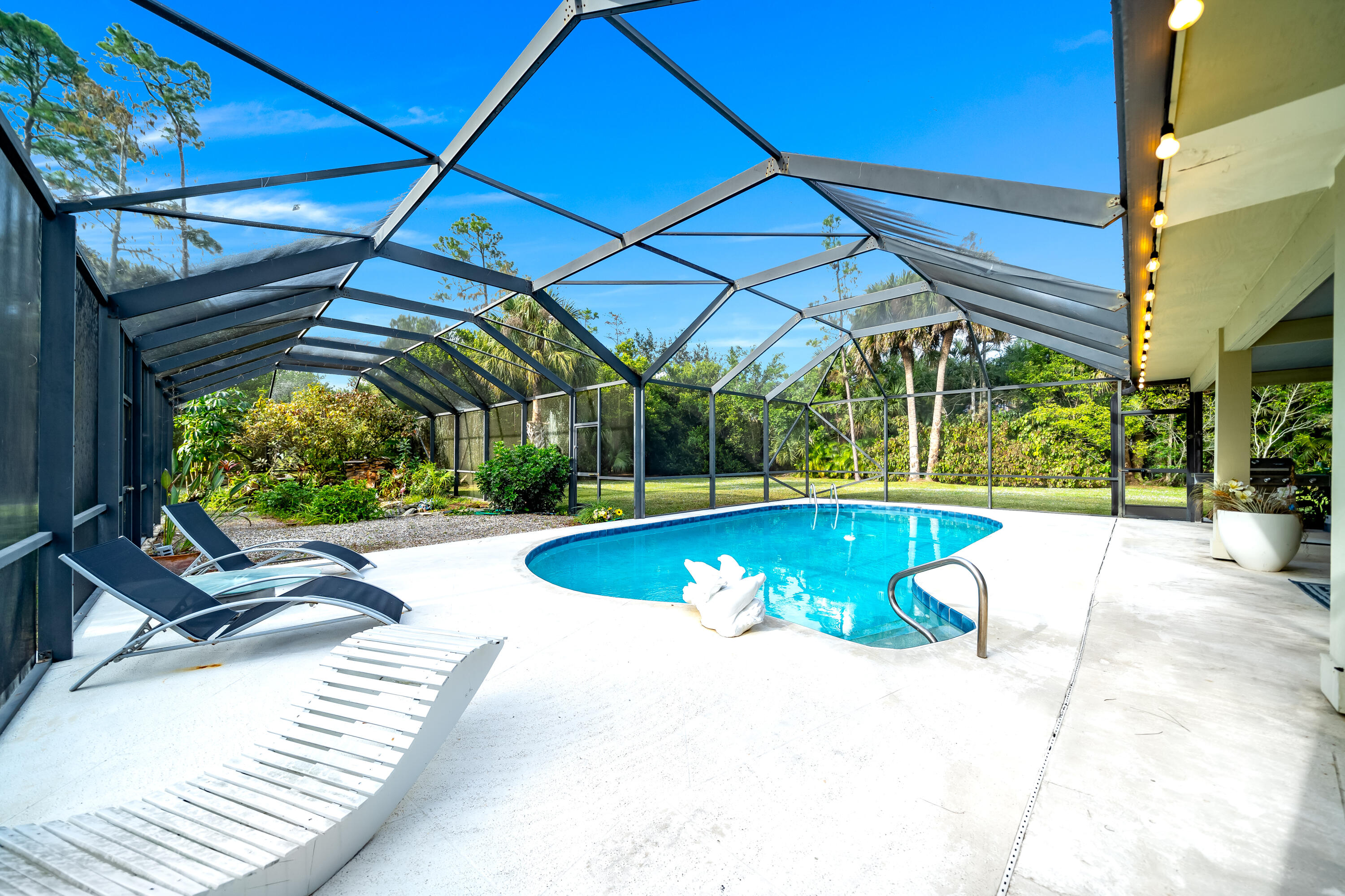 583 Rambling Dr Circle Wellington, FL 33414 - Photo 25 of 40 a view of a swimming pool with a patio