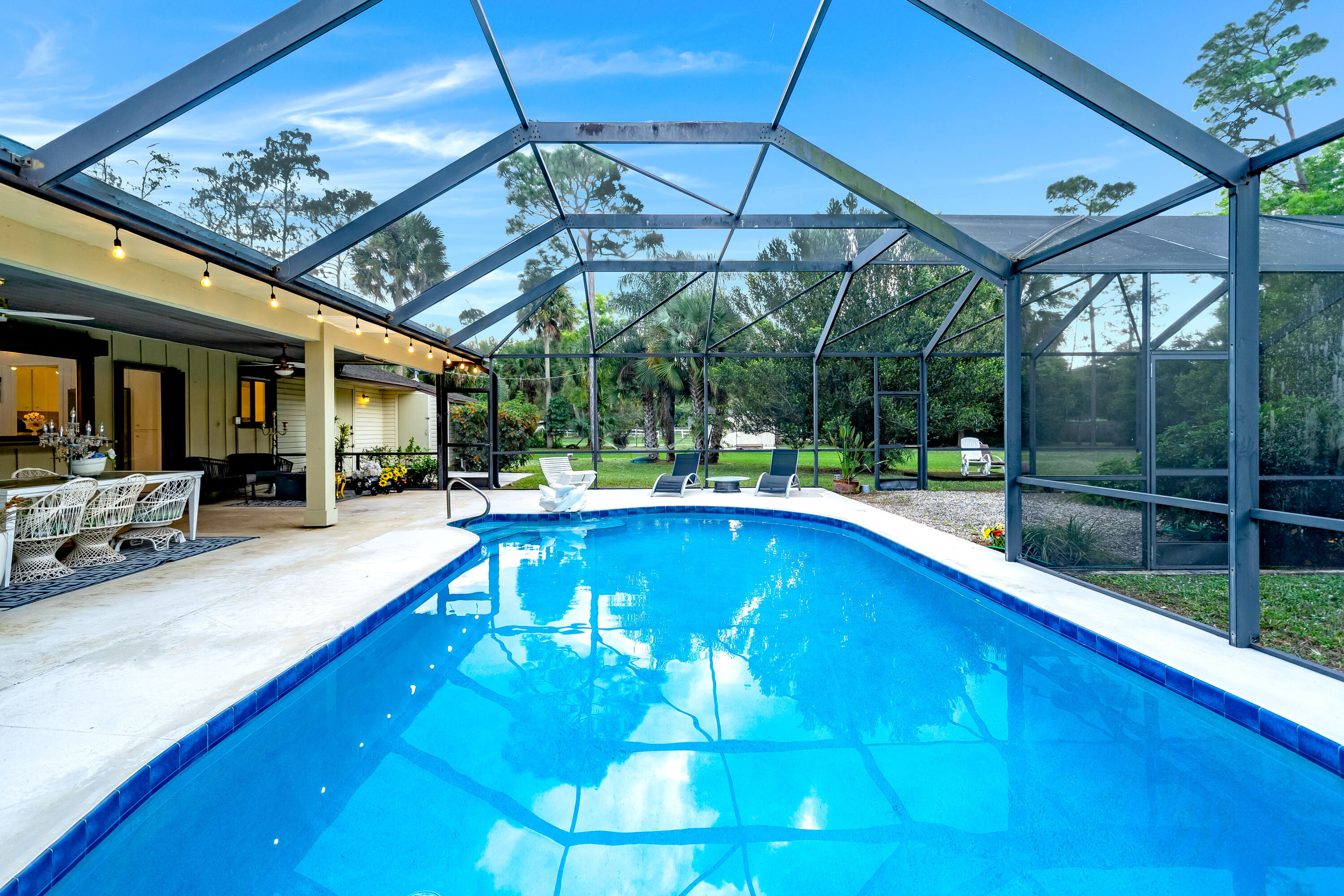 583 Rambling Dr Circle Wellington, FL 33414 - Photo 27 of 40 a view of a swimming pool with a patio