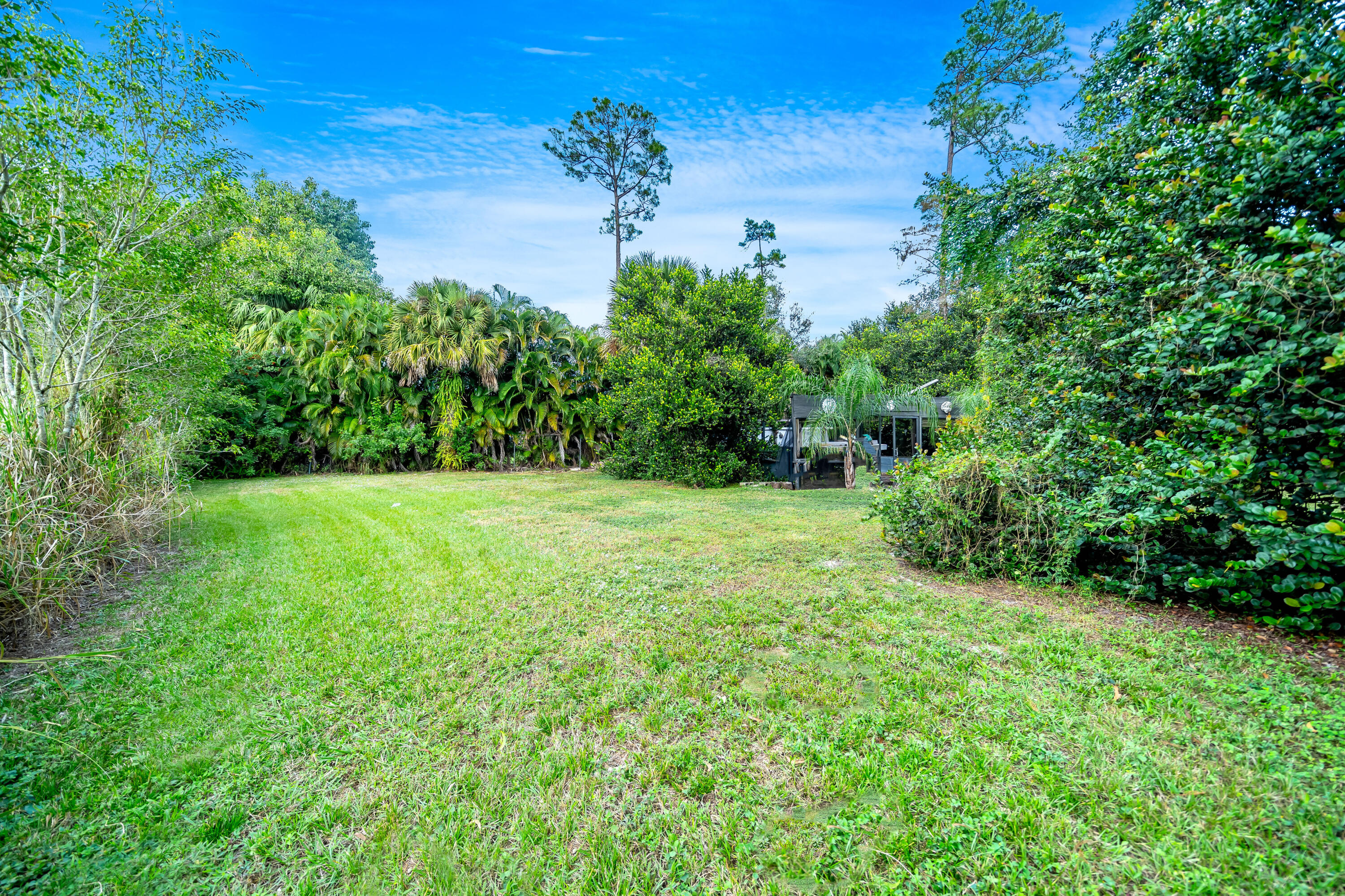 583 Rambling Dr Circle Wellington, FL 33414 - Photo 32 of 40 a view of a garden with a building in the background