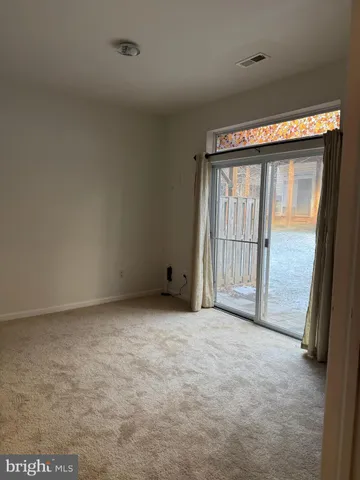 a view of an empty room with a fireplace