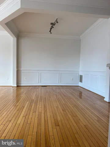 a view of an empty room and wooden floor