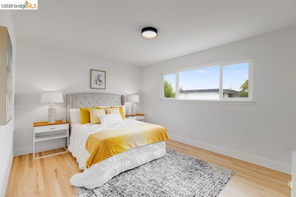 1298 Ribbon Street Foster City, CA 94404 - Photo 49 of 86 Bright room featuring light wood flooring, white walls, and a large horizontal window