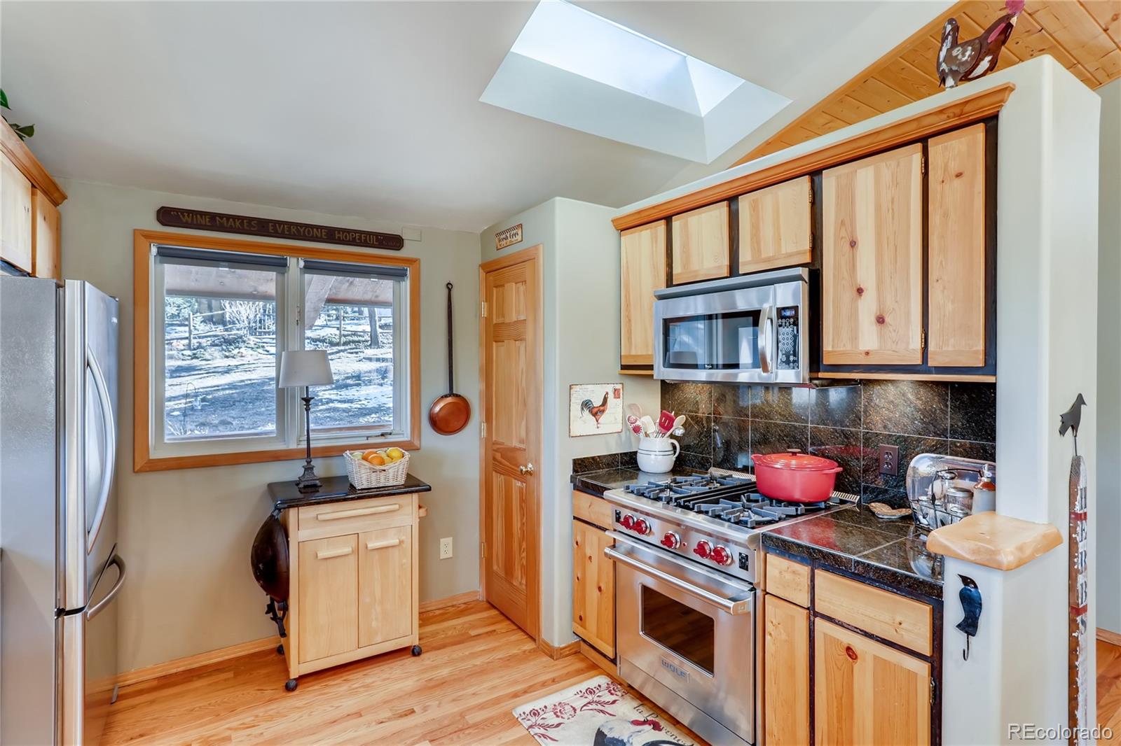 193 Twilight Terrace Drive Bailey, CO 80421 - Photo 11 of 34 a kitchen with stainless steel appliances granite countertop a stove and a refrigerator