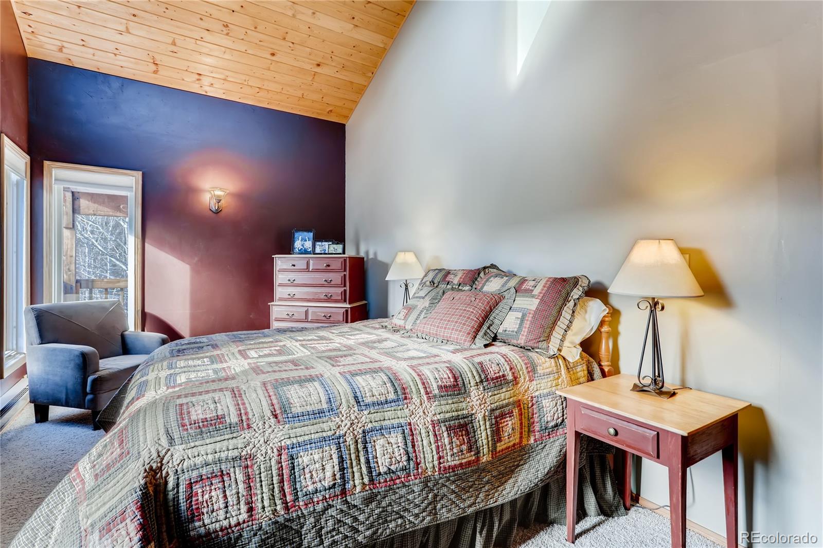 193 Twilight Terrace Drive Bailey, CO 80421 - Photo 12 of 34 a bedroom with a bed a mirror and lamp