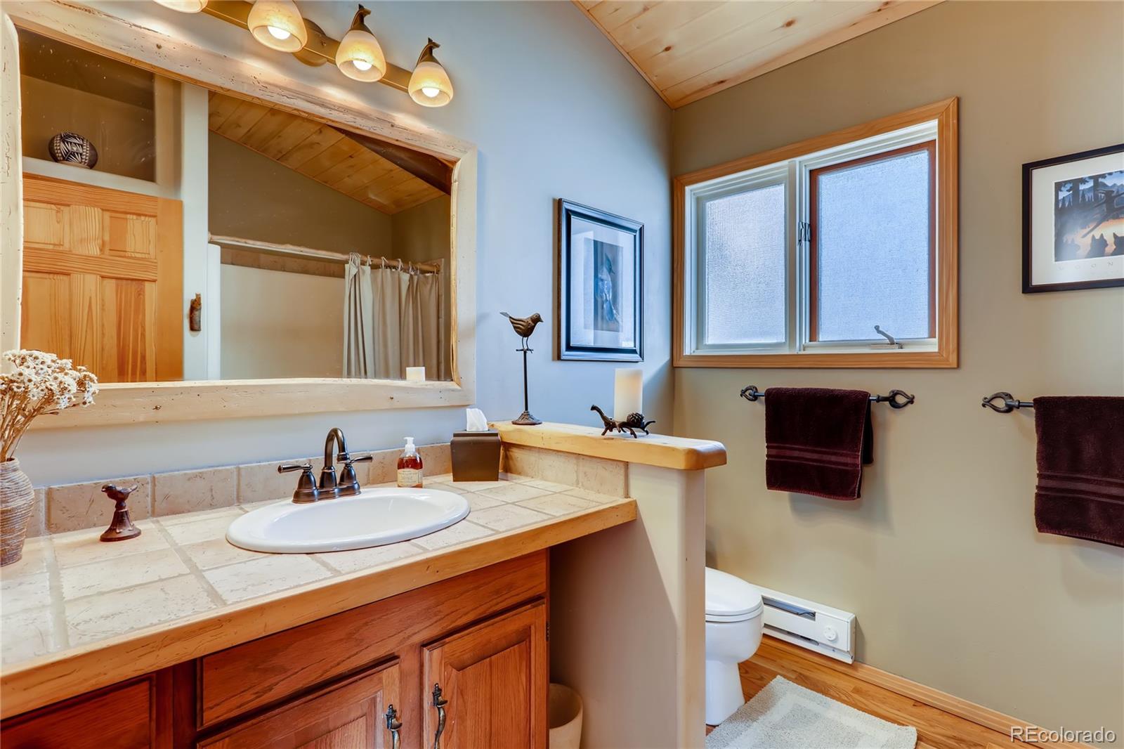 193 Twilight Terrace Drive Bailey, CO 80421 - Photo 13 of 34 a bathroom with a sink double vanity granite and a mirror