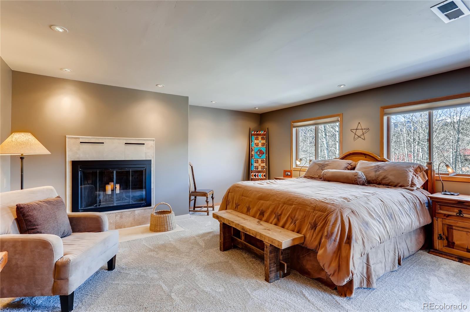 193 Twilight Terrace Drive Bailey, CO 80421 - Photo 15 of 34 a spacious bedroom with a bed and a fireplace