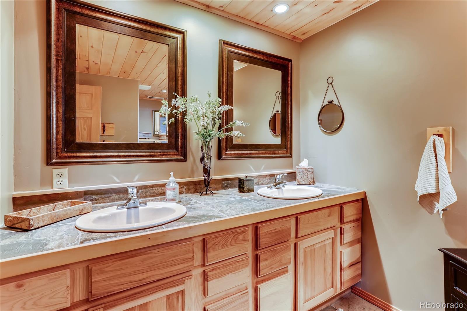 193 Twilight Terrace Drive Bailey, CO 80421 - Photo 17 of 34 a bathroom with a sink and a mirror