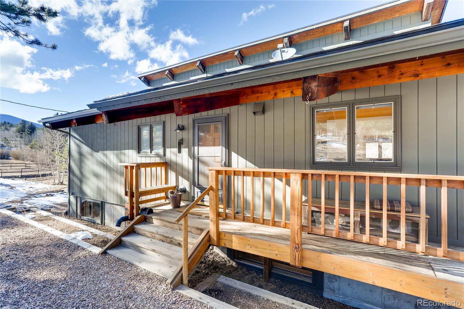 193 Twilight Terrace Drive Bailey, CO 80421 - Photo 2 of 34 a porch with a bench next to a window