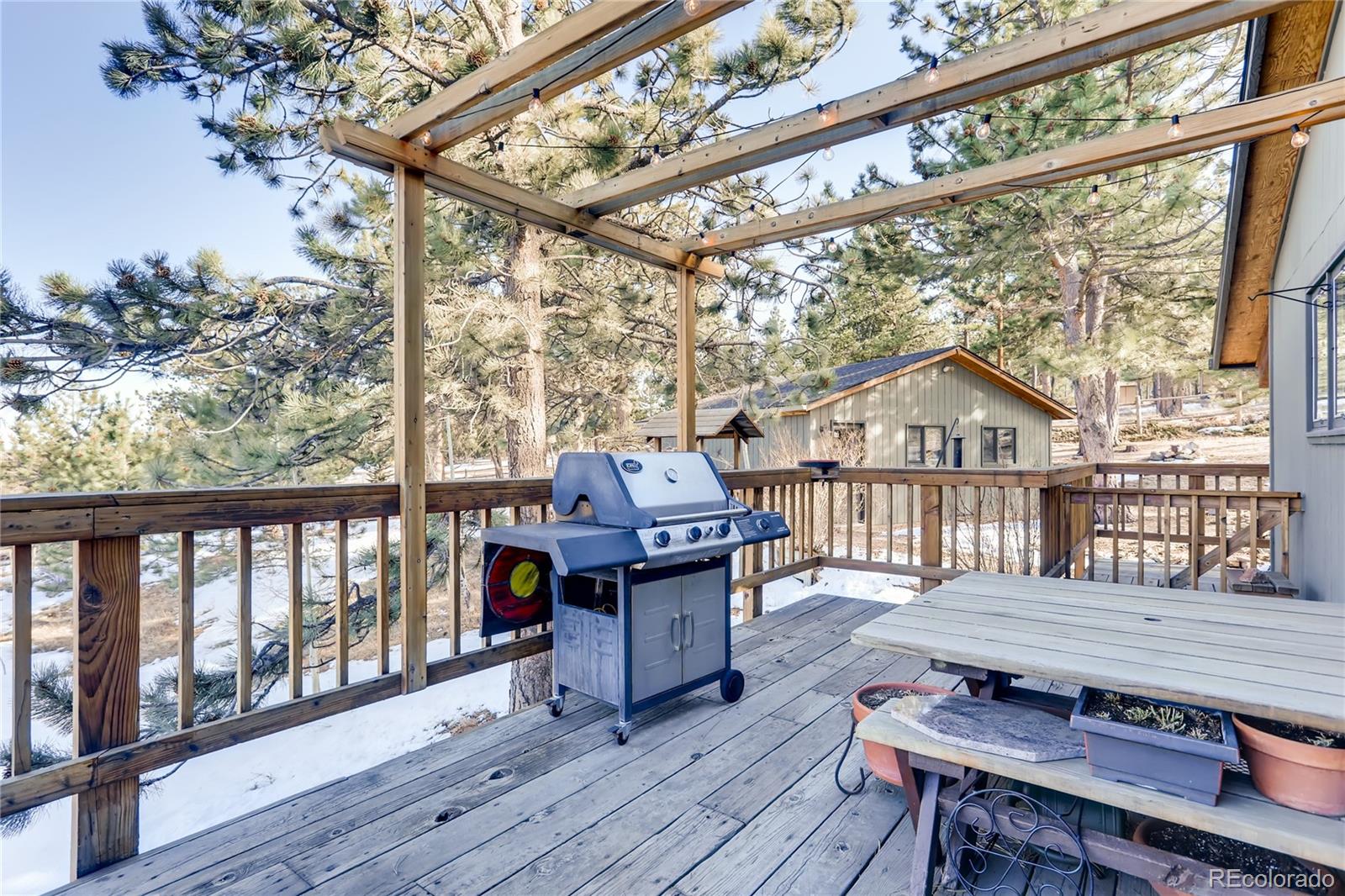 193 Twilight Terrace Drive Bailey, CO 80421 - Photo 22 of 34 a wooden bench sitting in front of a building
