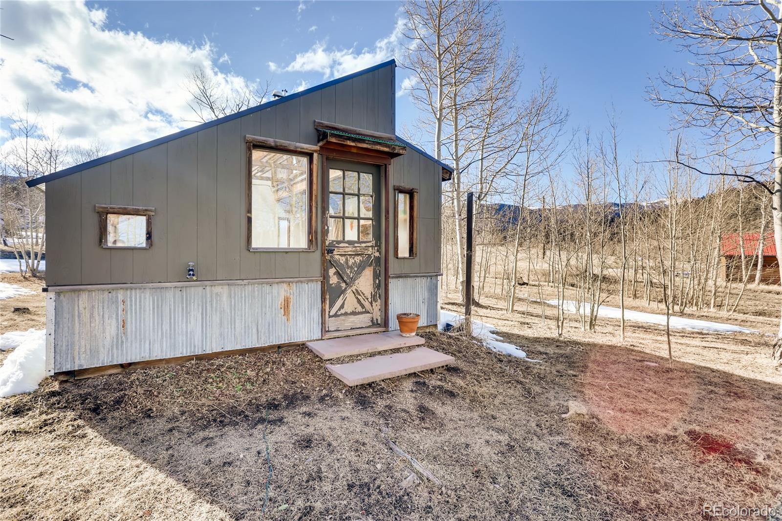 193 Twilight Terrace Drive Bailey, CO 80421 - Photo 24 of 34 a view of a house with a backyard and wooden fence
