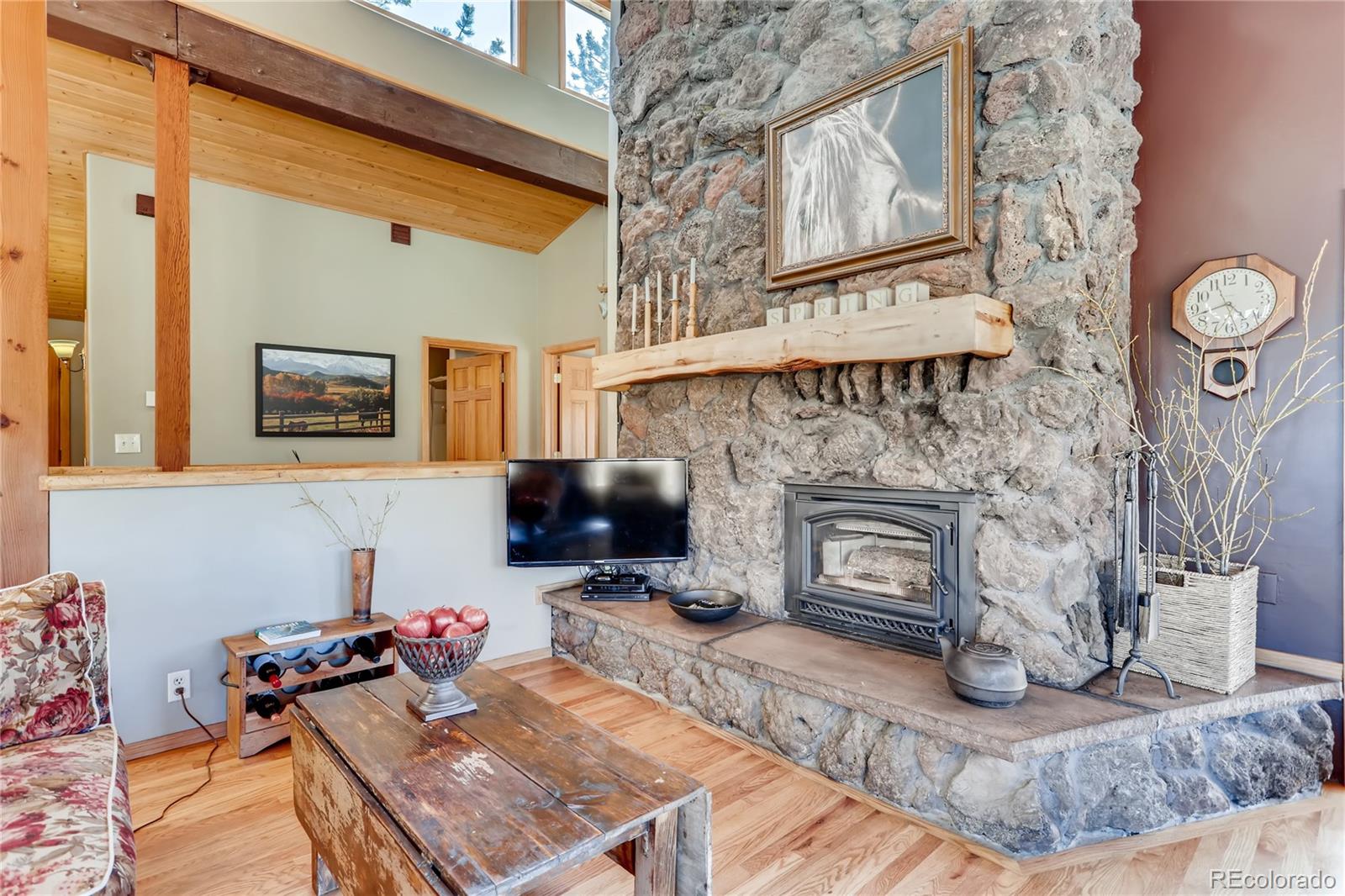 193 Twilight Terrace Drive Bailey, CO 80421 - Photo 5 of 34 a living room with furniture a flat screen tv and a fireplace