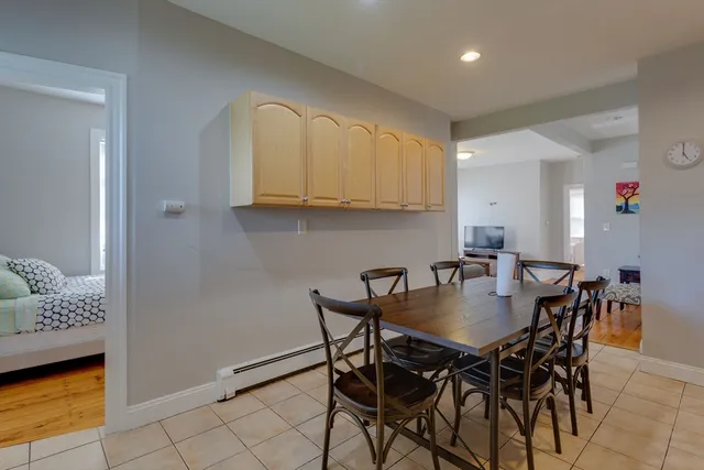 a view of a dining room with furniture and a potted plant