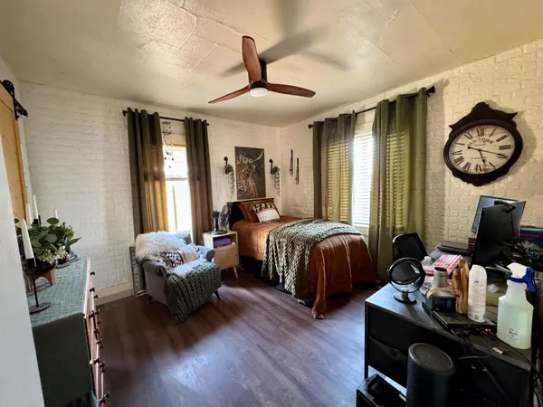 a bedroom with bed and a large window