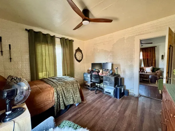 a bedroom with bed and a large window