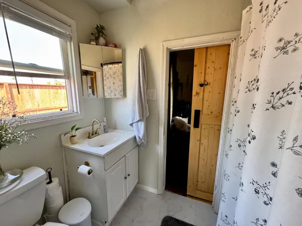 a bathroom with a toilet sink and mirror