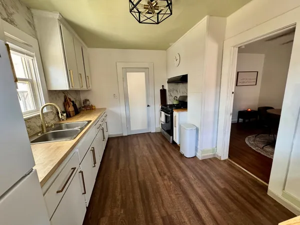 a kitchen with sink a refrigerator and a stove