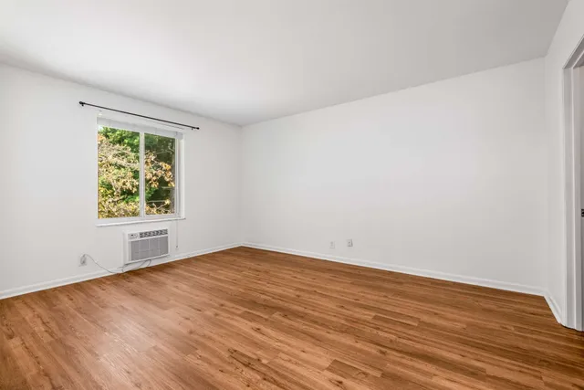 a view of a room with wooden floor