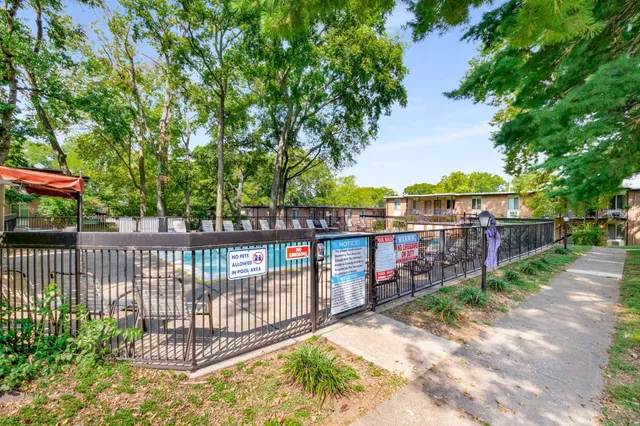 a kitchen with a sink a stove and white cabinets