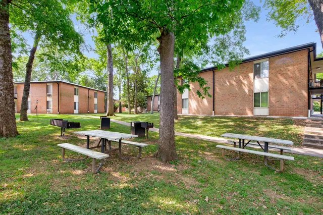 an aerial view of a city with lots of residential buildings ocean and mountain view in back