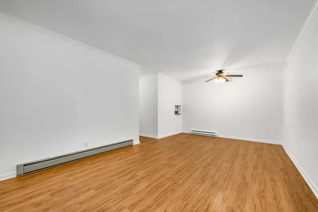 a view of an empty room and wooden floor