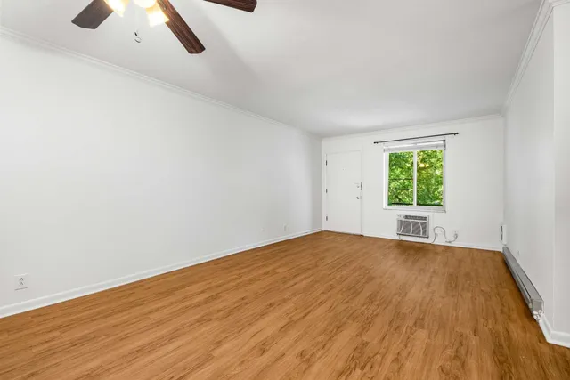 an empty room with windows and closet