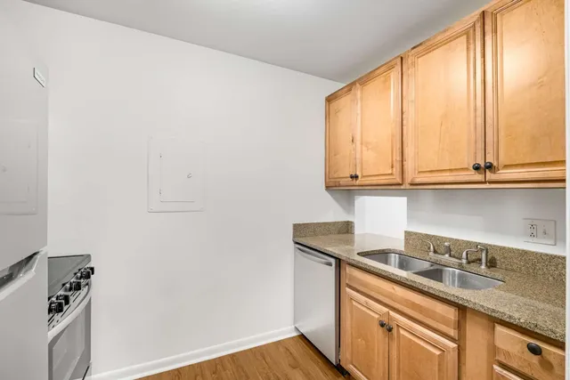 a kitchen with stainless steel appliances granite countertop a sink stove and cabinets