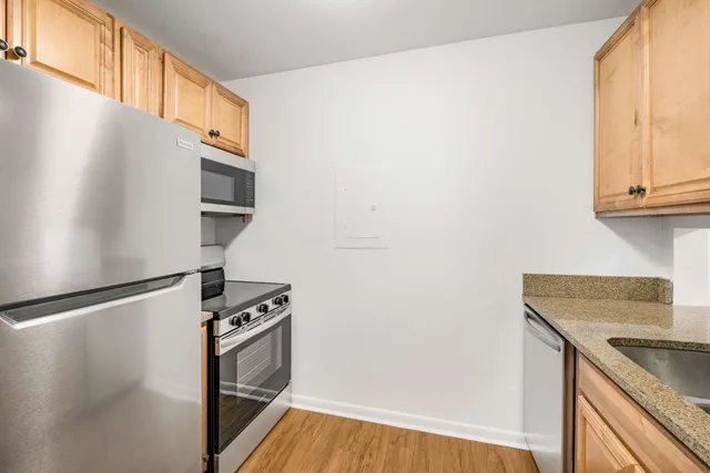 a kitchen with appliances and a microwave