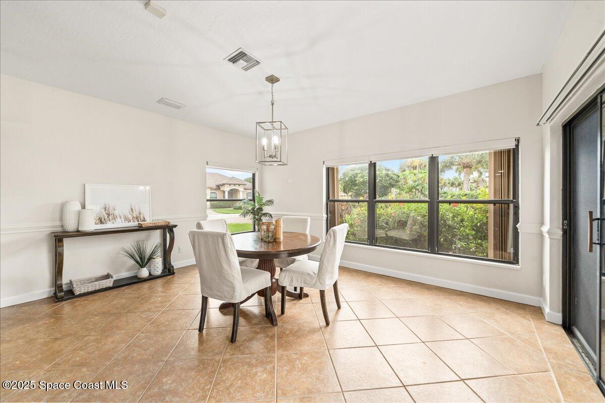 208 The Road, Unit C2 Melbourne Beach, FL 32951 - Photo 16 of 65 a dining room with furniture a chandelier and window
