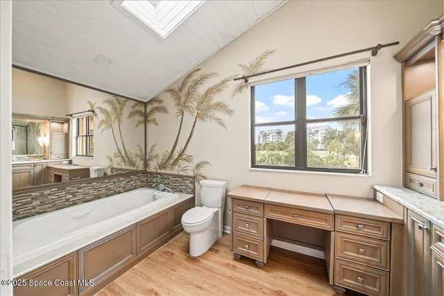 a bedroom with two beds and a large window