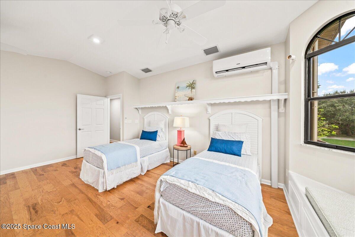 208 The Road, Unit C2 Melbourne Beach, FL 32951 - Photo 29 of 65 a bedroom with two beds and a large window