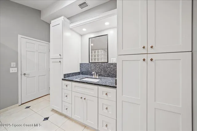 a bathroom with a sink and mirror