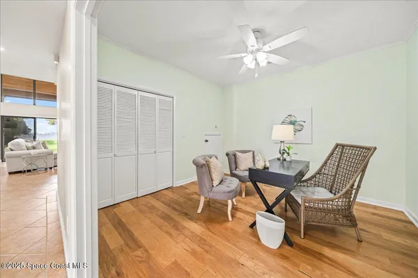 a front view of a house with a yard and palm trees