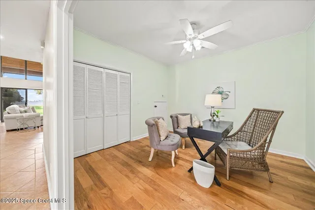 a front view of a house with a yard and palm trees