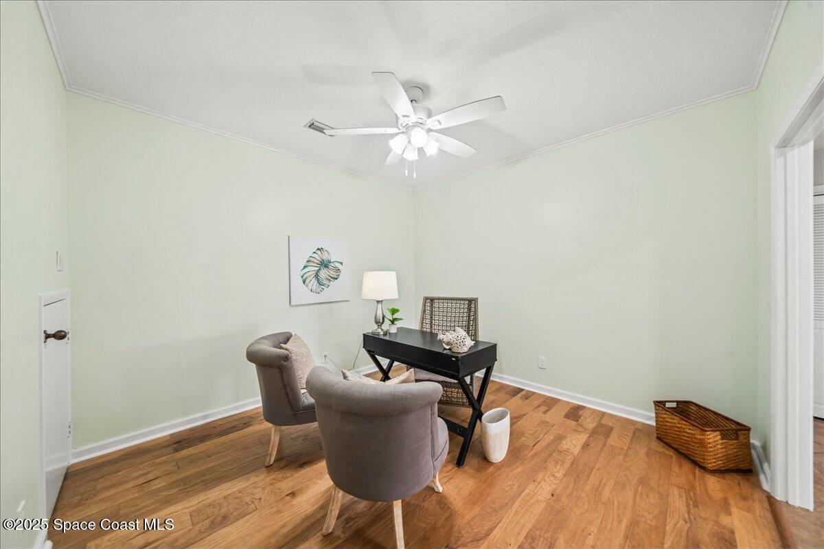 208 The Road, Unit C2 Melbourne Beach, FL 32951 - Photo 40 of 65 a workspace with furniture and wooden floor