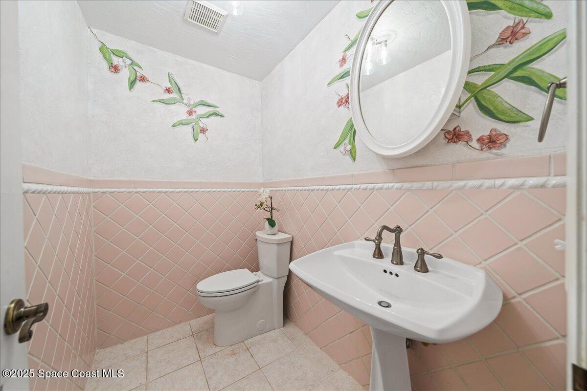 208 The Road, Unit C2 Melbourne Beach, FL 32951 - Photo 41 of 65 a bathroom with a sink and mirror