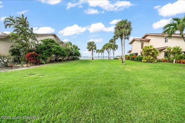 a dining room with furniture and a floor to ceiling window