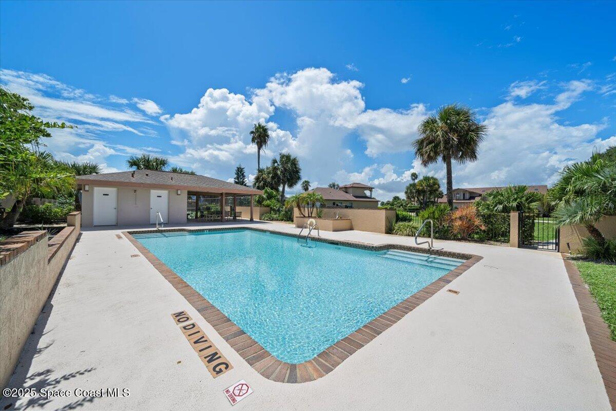 208 The Road, Unit C2 Melbourne Beach, FL 32951 - Photo 53 of 65 a view of a swimming pool with a patio