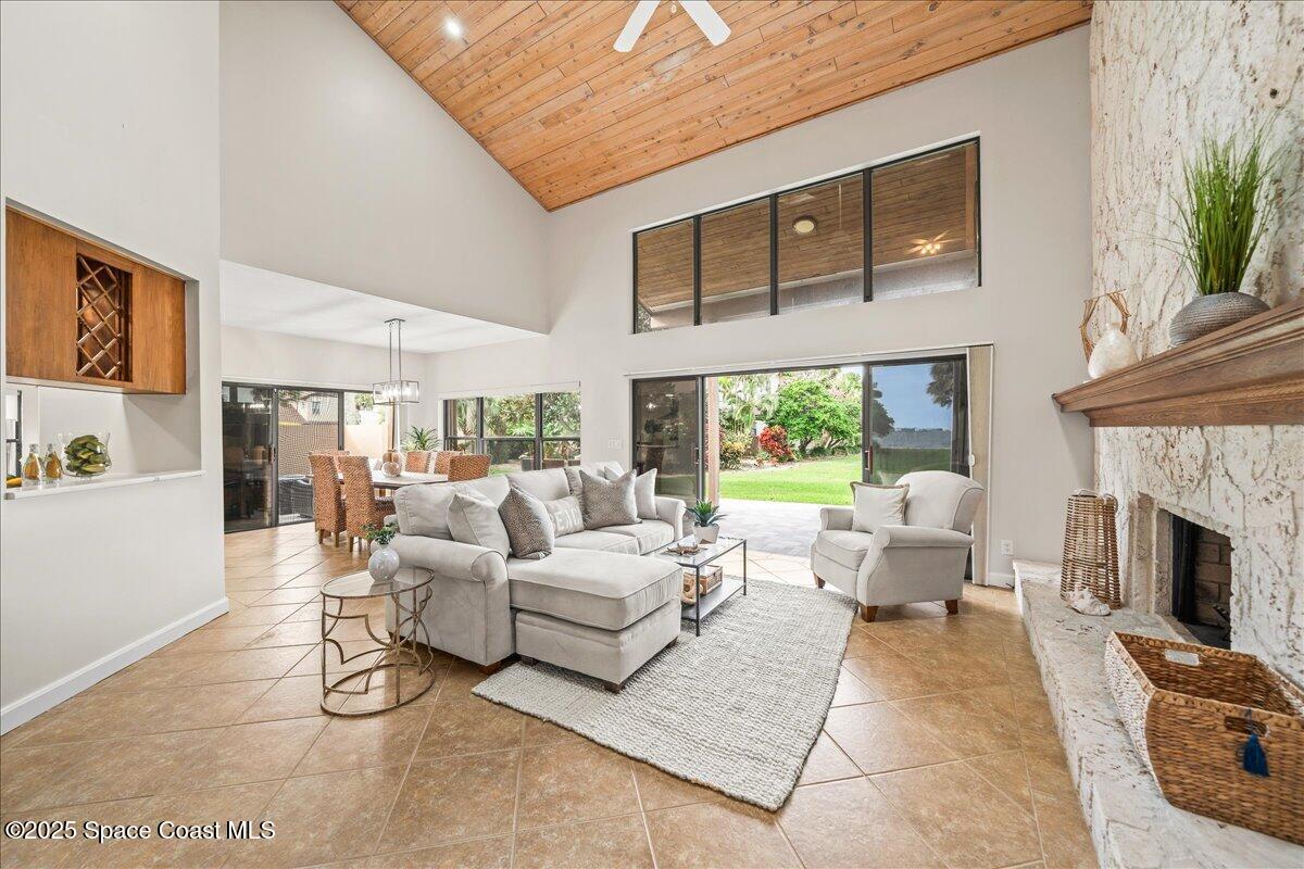 208 The Road, Unit C2 Melbourne Beach, FL 32951 - Photo 7 of 65 a living room with furniture fireplace and a large window
