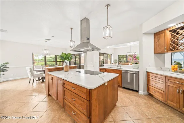 a view of a dining room and livingroom with furniture wooden floor a chandelier