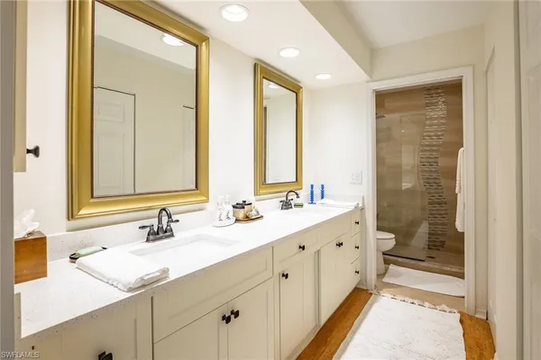 a bathroom with a granite countertop sink mirror and double